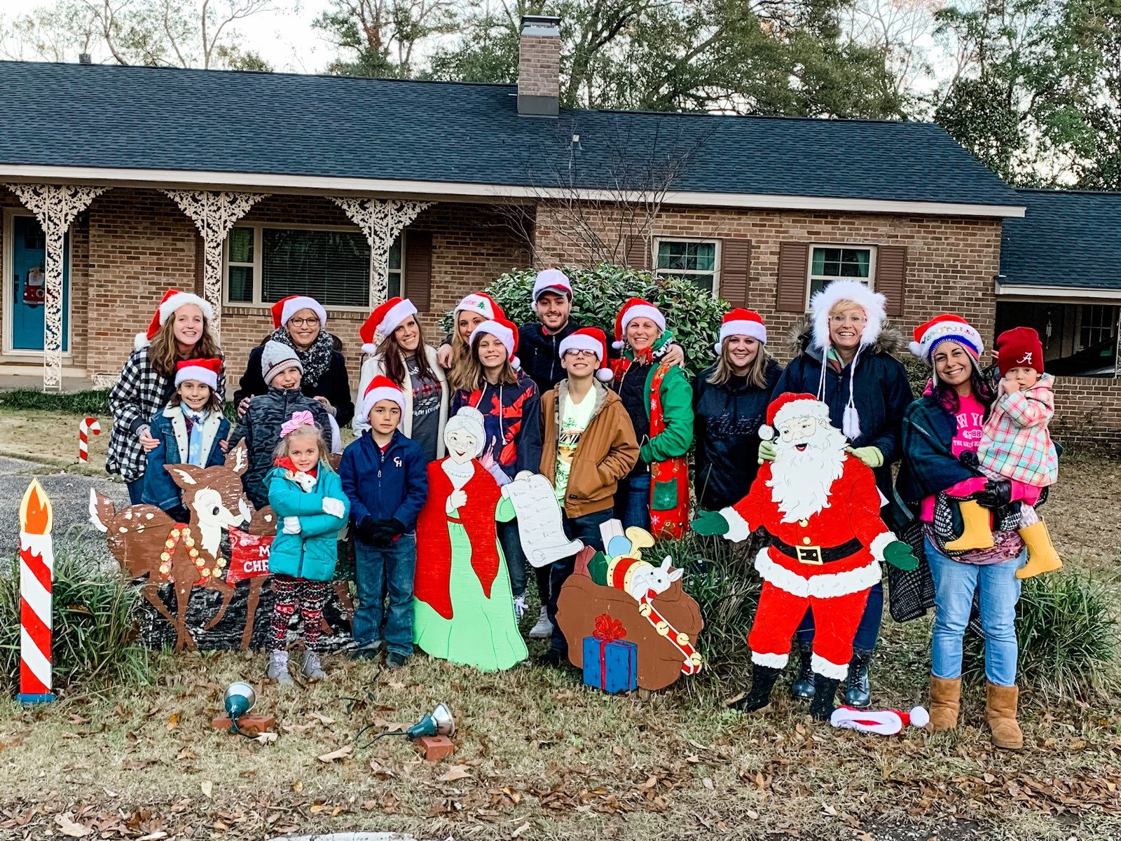 (Upload-from-mobile-1748618216)IMG_5865 Group of children and adults in Christmas attire posing outdoors.