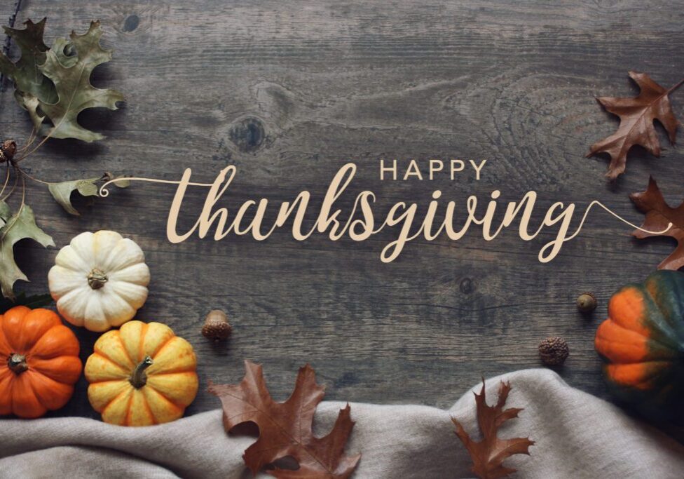 Happy Thanksgiving text with autumn decorations.